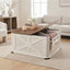 Mesa de centro blanca con diseño de granero, tapa de madera y compartimiento de almacenamiento elevable.